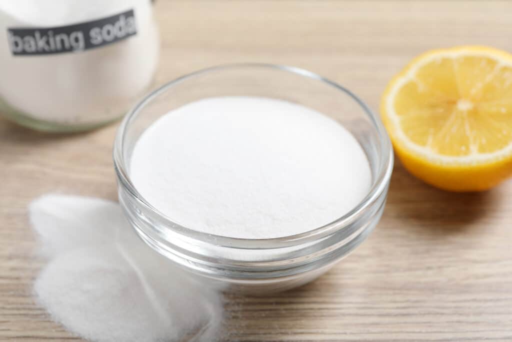 a shallow dish of baking soda and sugar placed under a kitchen sink as a DIY roach bait